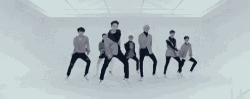 a group of young men are dancing in a room .