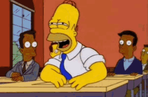 a cartoon of homer simpson sitting at a desk