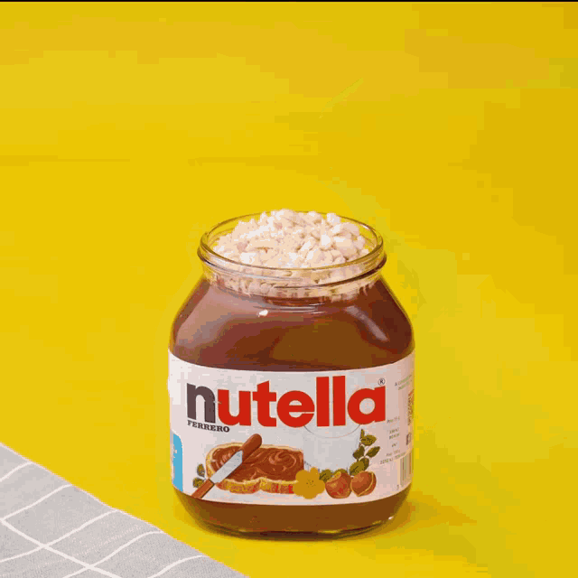 a jar of nutella is being stirred with a spoon