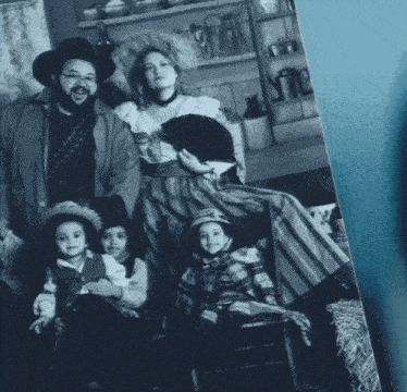 a black and white photo of a family dressed as cowboys and cowgirls