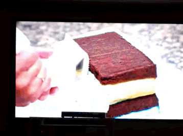 a tv screen shows a piece of chocolate cake on a plate