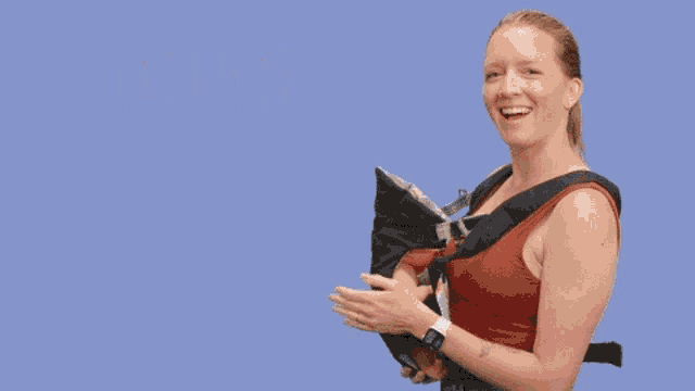 a woman holding a baby in a carrier with the words you 're doing great momma