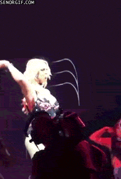 a woman singing into a microphone on a stage with senorgif.com in the corner