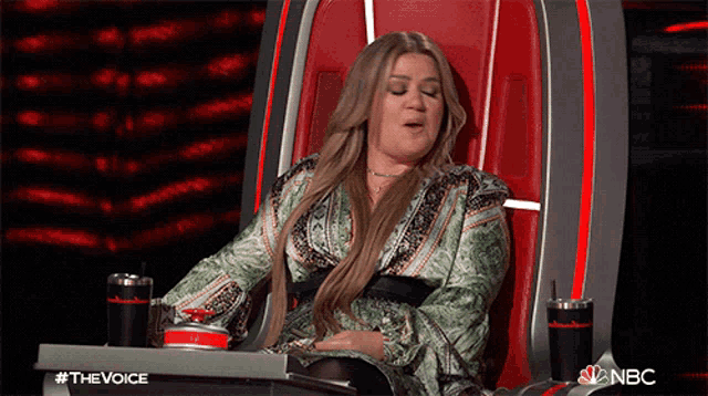 a woman is sitting in a chair that says nbc