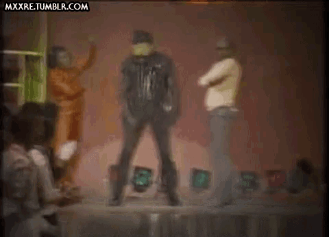 a group of people are dancing on a stage with the website mxxre.tumblr.com visible in the corner .
