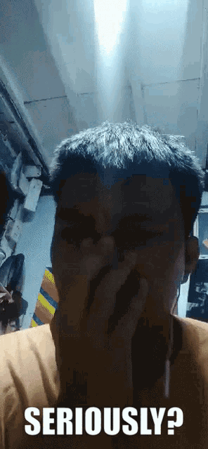 a man covering his mouth with his hand and the words seriously written on the bottom