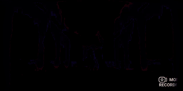a girl in a white dress is dancing in a dark room with red lights