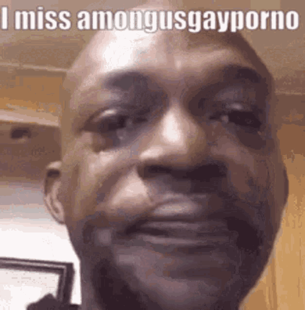 a close up of a man 's face with the words `` i miss among us gay porno '' written on it .