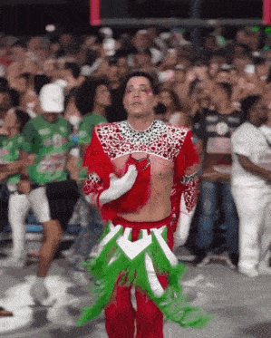 a man in a red and green outfit is dancing