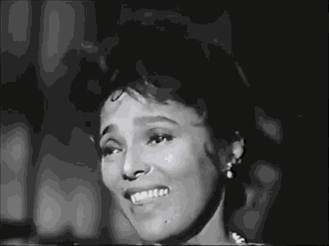 a black and white photo of a woman singing a song