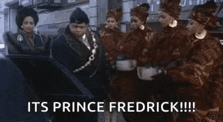 a group of people are standing around a carriage with the words `` its prince fredrick !!! '' .