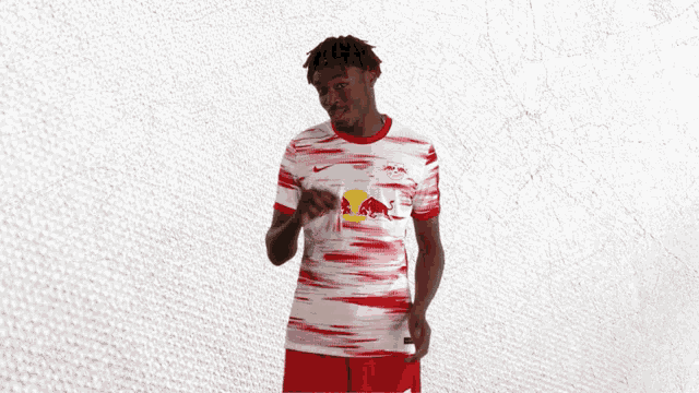 a man wearing a red and white jersey with a red bull on it