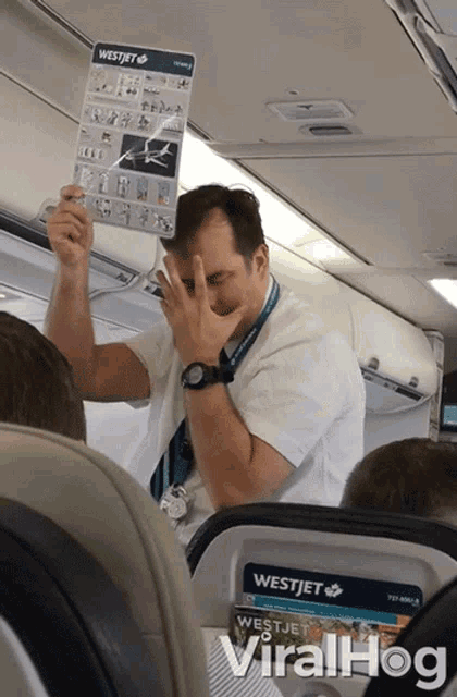 a man covering his face with a westjet sign