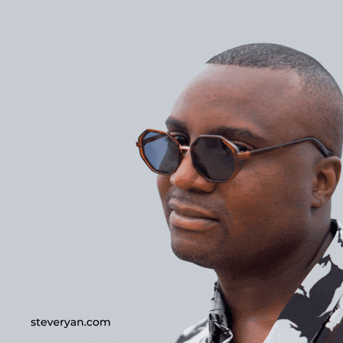 a man wearing sunglasses with gm gm written on the top