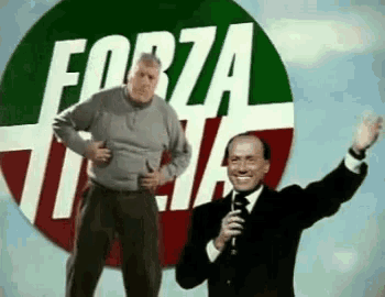 two men are standing in front of a forza italia sign