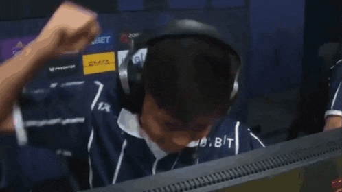 a man wearing headphones is playing a video game with intel logos on the screen