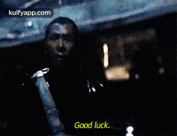 a man is holding a gun and says good luck