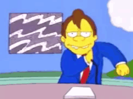 a cartoon of a man in a suit and tie sitting at a desk