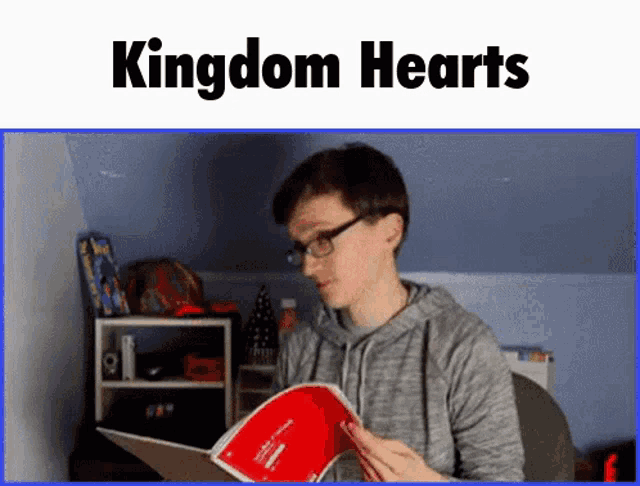 a man wearing glasses is reading a book with the title kingdom hearts