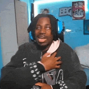 a man wearing headphones is making a funny face while standing in a room .