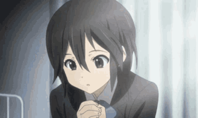 a girl with short black hair is wearing a tie