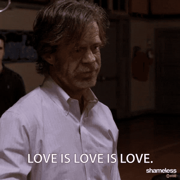 a man in a white shirt is saying love is love