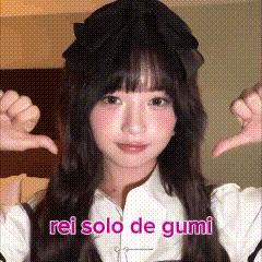 a girl wearing a black hat and a white shirt is giving a thumbs down sign