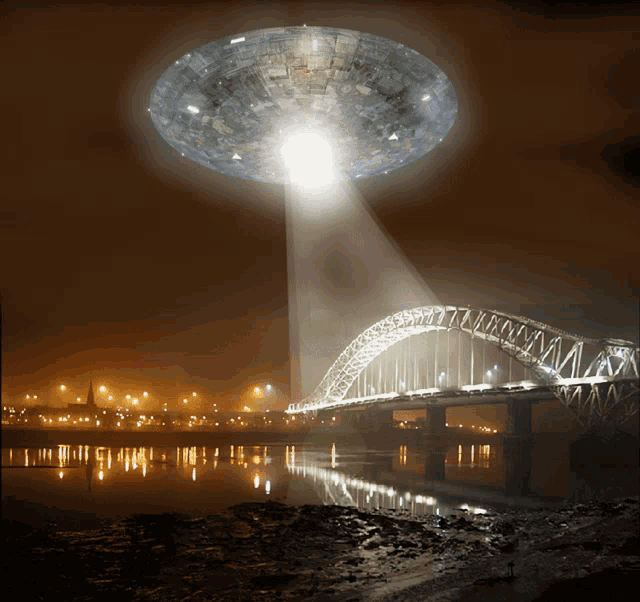 a bridge is lit up at night with a ufo flying over it