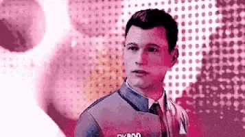 a man in a suit and tie is standing in front of a pink and white background .