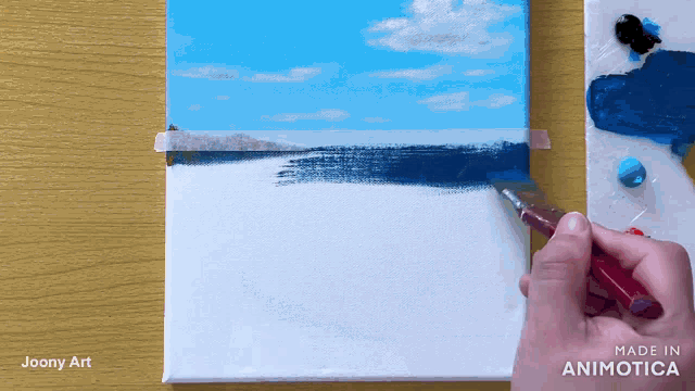 a person is painting on a canvas with the words made in animatica visible