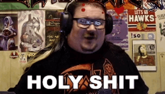 a man wearing headphones and a shirt that says holy shit on it