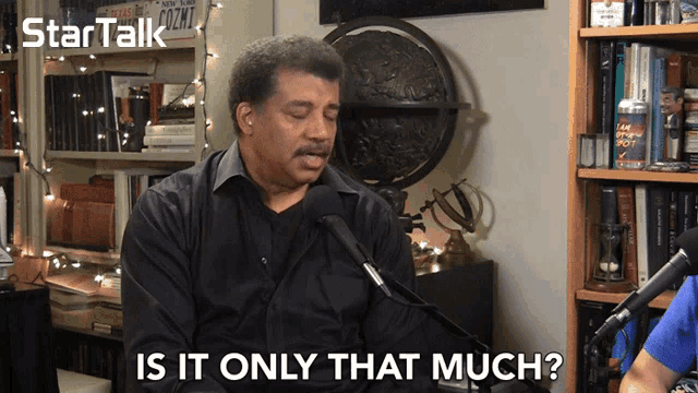 a man sitting in front of a microphone with the words is it only that much