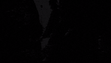 a black and white photo of a man kissing a woman on a street