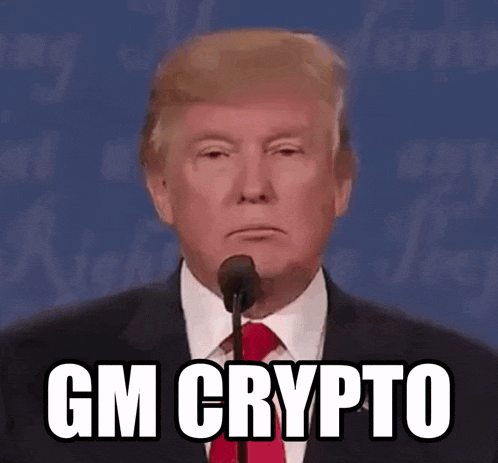 donald trump is talking into a microphone and says gm crypto