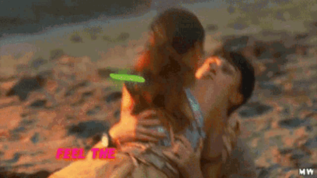 a man and woman are laying on the beach with the words `` feel the beat , feel the init '' written on the bottom .
