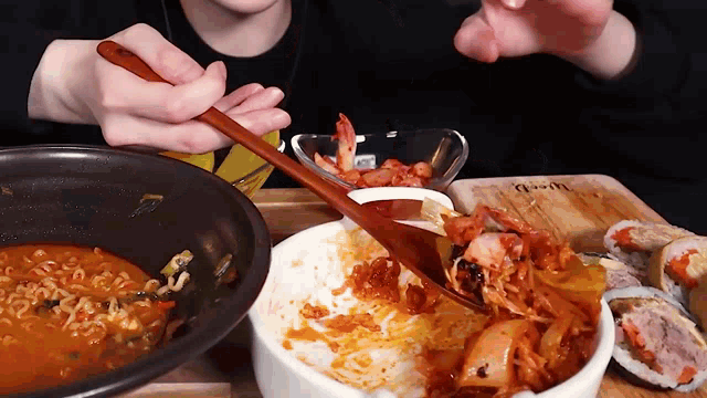 a person is eating food with a wooden spoon