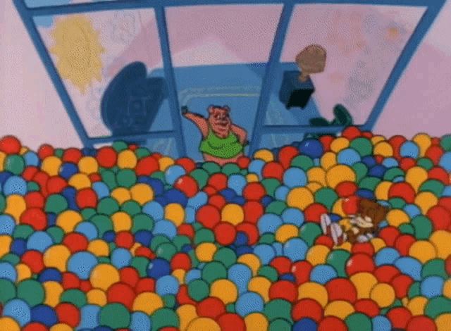 a cartoon character is standing in a ball pit full of colorful balls