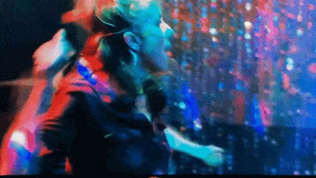 a woman singing into a microphone in a club
