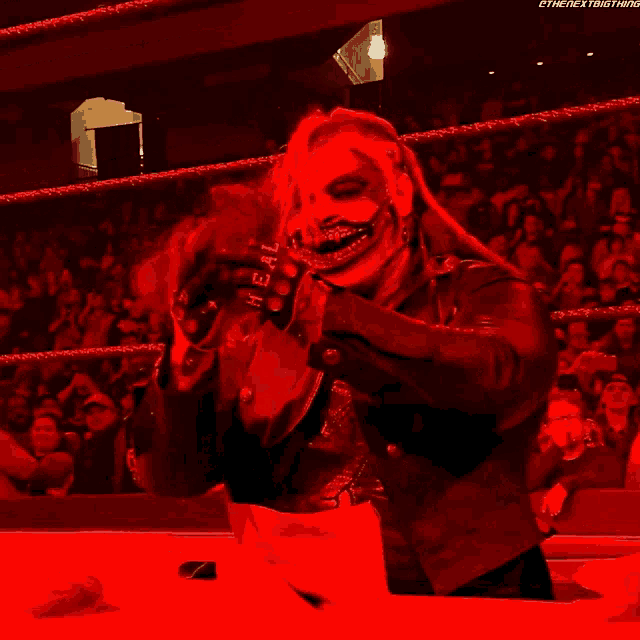 a wrestler with a mask and gloves that say heal