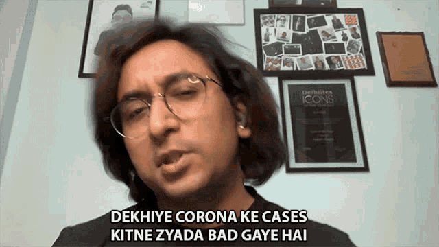 a man wearing glasses and a black shirt says dekhiye corona ke cases kitne zyada bad gaye hai