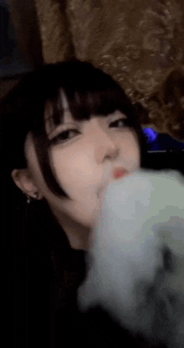 a close up of a woman smoking a cigarette