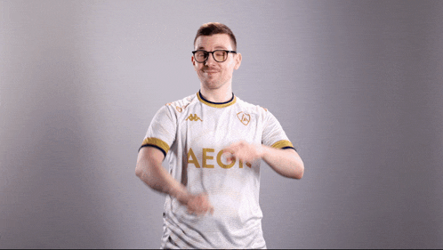 a man wearing glasses and a white shirt with the word aegis on it