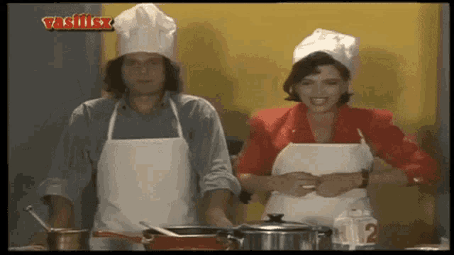 a man and a woman wearing chef hats and aprons with vasilisx written on the bottom right