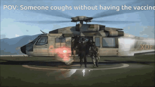 two soldiers are standing in front of a helicopter that says xof on the side