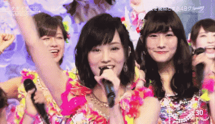 a group of women are singing into microphones with the number 30 on the bottom