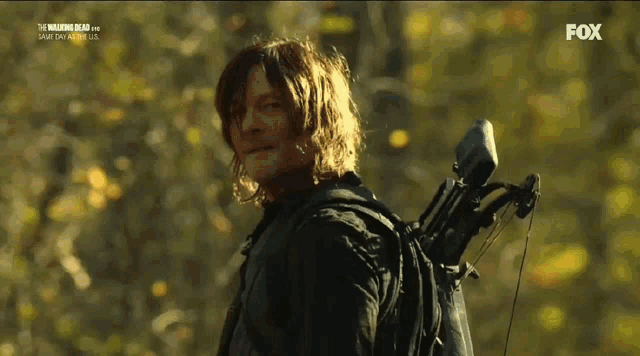 a man carrying a bow and arrow on his back is on fox
