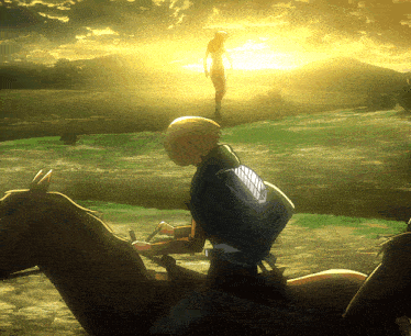 a man is riding a horse in a field while a man stands in the background
