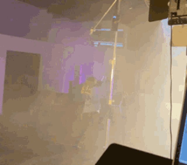 a person standing in a room with purple lights