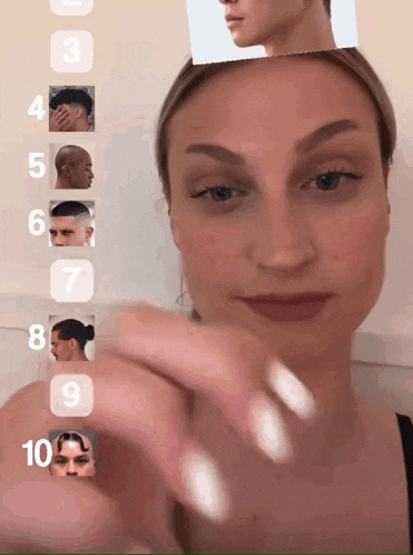 a woman is holding up a picture of a man 's face with the number 3 through 10 on it
