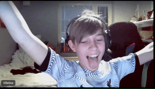 a boy wearing headphones and a shirt with the name villelina on the bottom